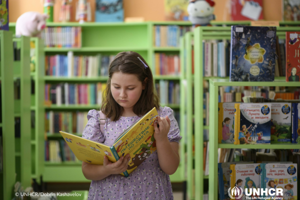 A girl reading a book in the library