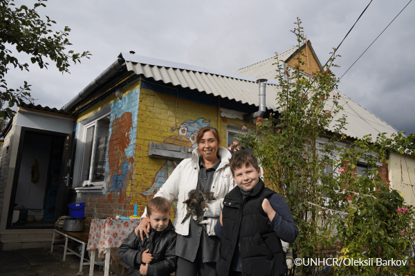 a family in front of the house